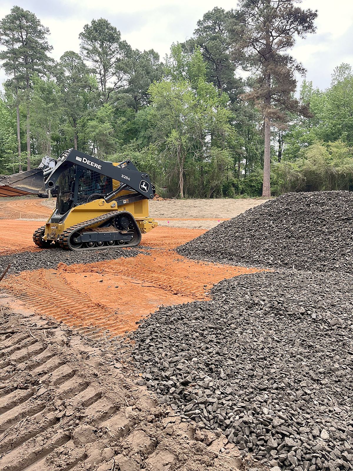 Spreading rock on a fresh drive
